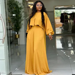 Elegant mustard yellow two-piece set with lantern sleeve top and beaded wide-leg pants