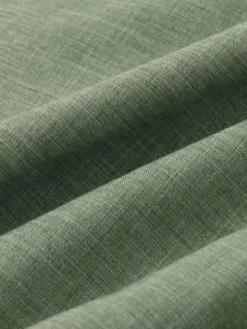 Detailed macro view of green breathable cotton linen fabric texture for men's summer shirt