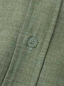 Close-up of olive green cotton linen shirt showing fabric texture and button detail