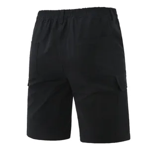 Detailed back view of mens black solid color multi-pocket cargo shorts for outdoor use