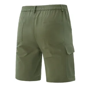 Back view of men's olive green outdoor cargo shorts with multi-pocket design and elastic waist