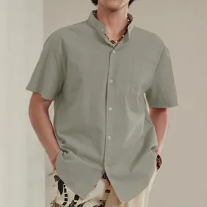 Detail view of men's sage green linen shirt with mandarin collar and front pocket