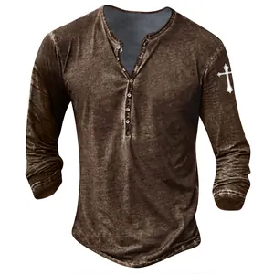 Detailed view of men's vintage brown Henley shirt with cross print on the sleeve