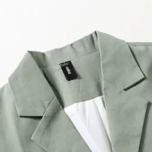 Close-up detail of a men's retro cotton linen casual blazer collar and neck label