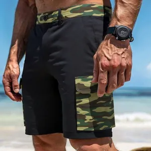 Detail of men's black cargo shorts with camouflage pockets at the beach.