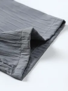 Close-up of the textured vertical stripe fabric and hem stitching of a grey men's shirt