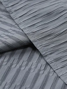 Close-up macro view of the grey textured crinkled fabric for men's summer shirt