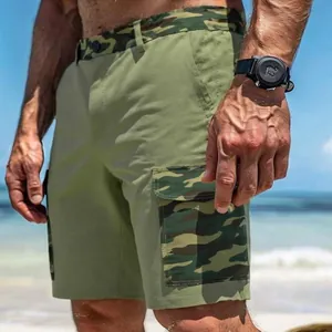 Close-up of men's cargo shorts with camouflage pockets in a sunny outdoor beach setting