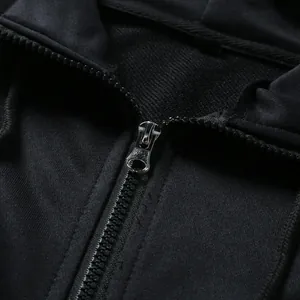 Close-up of durable metal zipper and soft fabric texture on black men's hoodie.