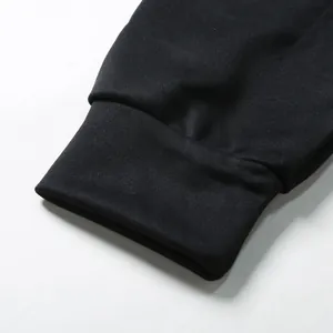 Detailed macro shot showing the elastic ribbed cuff of a black hooded sweatshirt