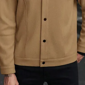 Vue détaillée montrant la texture du tissu et les boutons noirs d'une veste en laine kaki homme