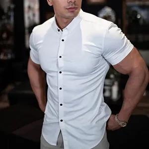Athletic muscle fit white short sleeve button down shirt shown on fit male model