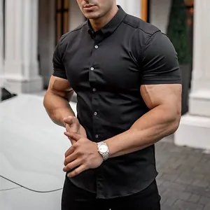 Close-up of a men's muscle fit short sleeve button-down shirt in solid black color