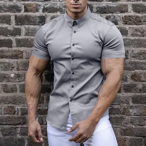 Front view of a gray muscle fit short sleeve button-up shirt worn by an athletic male model