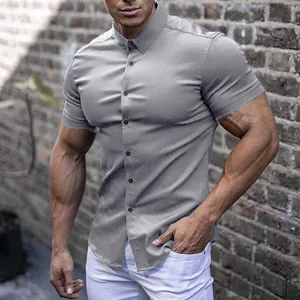 Men's slim fit grey short sleeve muscle shirt shown in a casual urban street setting