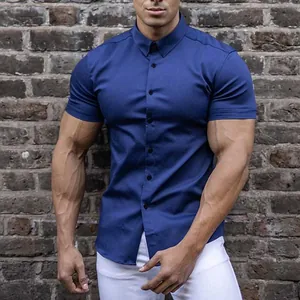 Close-up detail of navy blue muscular fit short sleeve shirt with brick wall backdrop