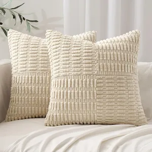 Detailed texture of beige patchwork corn kernel textured cushion covers on a sofa.