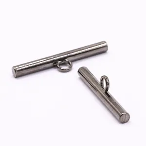 Close-up macro detail of dark gunmetal bar-shaped alloy shank buttons for apparel