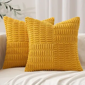 Close-up macro shot of yellow corn-kernel patchwork texture on decorative pillow covers