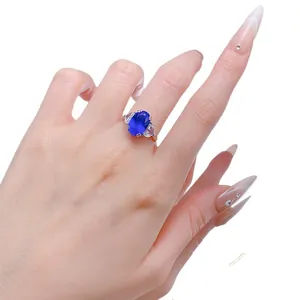 Eleganter S925 Silberring mit großem ovalen blauen Saphir und Steinen an der Hand