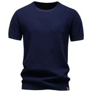 Macro view of the textured navy blue knit fabric on a men's crew neck T-shirt