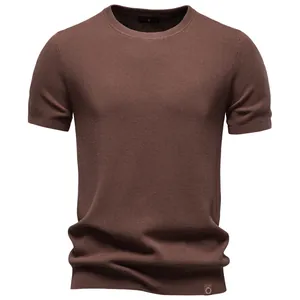 Detailed view of dark brown men's crew-neck knit T-shirt with waffle texture.