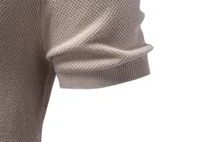 Macro view of textured knit fabric and ribbed cuff on men's beige short sleeve T-shirt