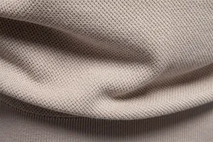 Macro detail of silky knit fabric texture on men's leisure short sleeve T-shirt.