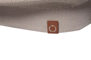 Macro detail of men's crew neck T-shirt hem with woven label and smooth knit texture