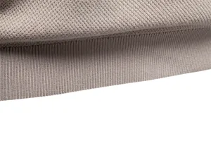 Close-up of the ribbed hem and textured knit fabric on a men's silky crew neck t-shirt.