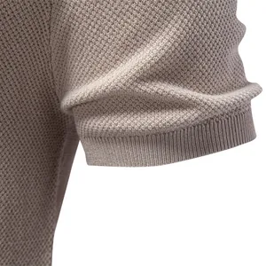 Detailed view of beige men's round neck T-shirt with honeycomb knit and ribbed sleeve.