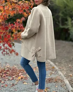 Detail view of a beige women wool coat featuring a stylish side bow and lapel collar.