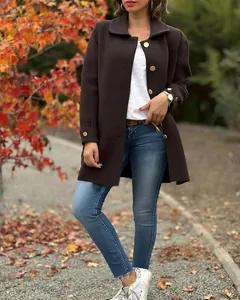 Close-up detail of stylish women's dark brown lapel wool coat featuring golden buttons for autumn