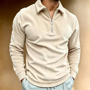 Detail of men's beige corduroy polo shirt with a silver half-zip and ribbed cuffs.
