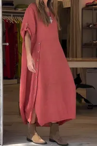 Terracotta linen maxi dress featuring a loose fit and unique diagonal button detailing.