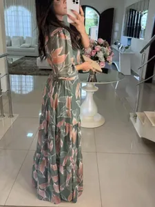 Elegant sage green floral maxi dress with long sleeves and tiered skirt design