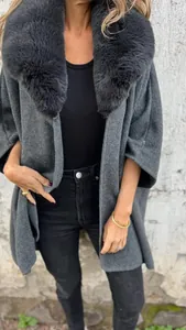 Chic women's oversized dark grey cape coat featuring a luxurious large faux fur collar