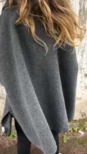 Close-up back view of a grey loose woolen poncho coat for women's autumn winter style