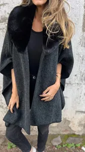 Detail of women's dark grey cloak coat featuring a premium lush black faux fur collar