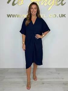 Full view of navy blue V-neck dress with front knot detail and loose batwing sleeves