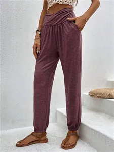 Detail of high-waisted mauve lounge joggers with crossover waist and side pockets.