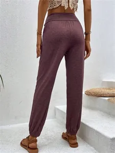 Back view of women's mauve high-waisted casual joggers with elastic cuffs for lounge wear