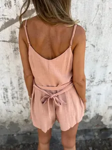 Detailed back view of women's blush cotton linen romper with a delicate bow tie