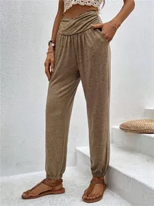 Detailed view of women's high-waisted crossover joggers in taupe with side pockets