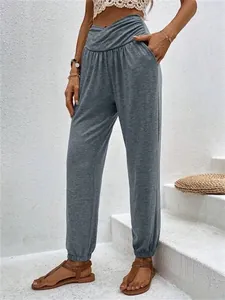 Full view of women's casual grey high-waisted joggers with pocket details