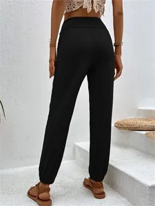 Back view of black high-waisted joggers with elastic cuffs for casual home wear.