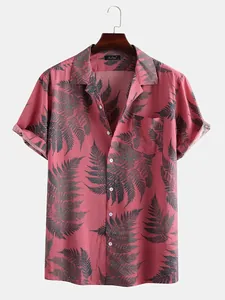 Pink Hawaiian shirt detail featuring dark green fern leaf prints and casual camp collar.