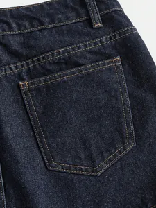 Close-up detail of back pocket and stitching on a dark blue high-waisted denim skirt