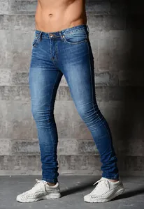 Side view of men's slim fit blue skinny jeans with distressed washed denim texture