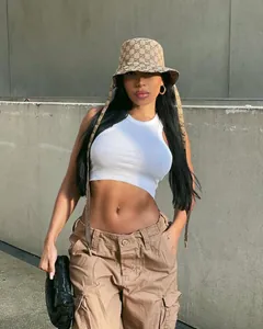 Detailed view of khaki cargo pants with multiple pockets on a street style model